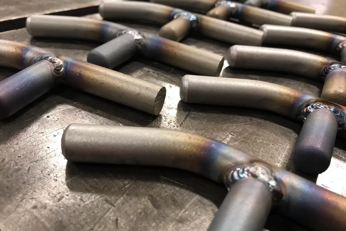 Welded steel tube fittings on a steel table